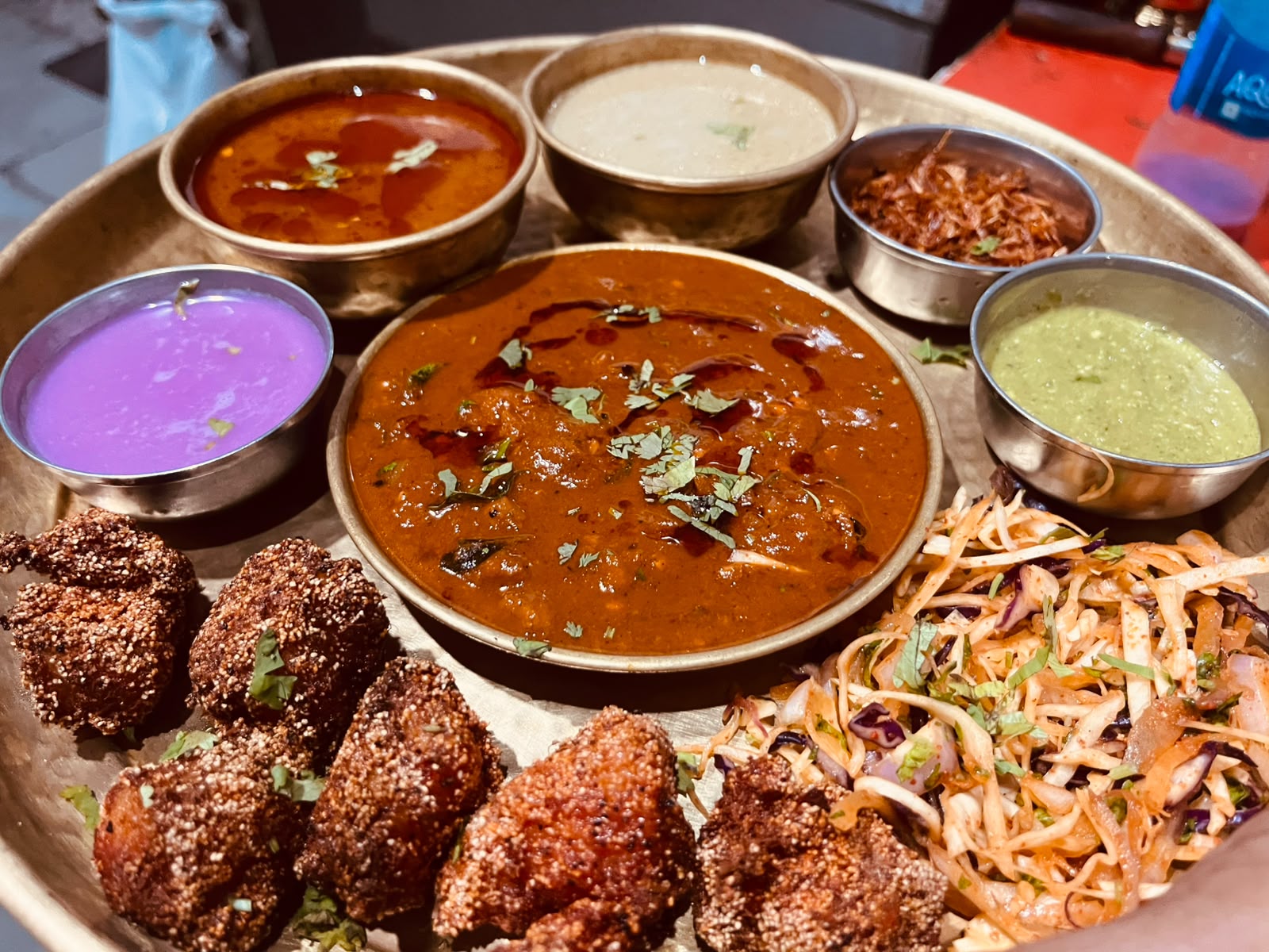 A traditional thali with curries and crisp accompaniments