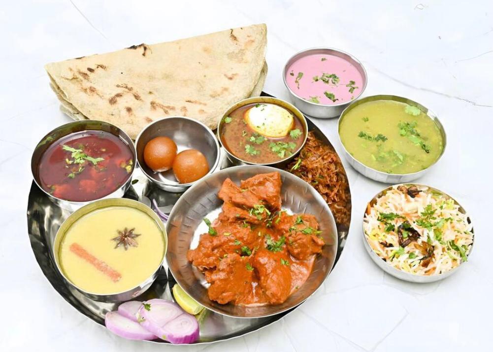 Non-veg thali spread with bhakri and sweets