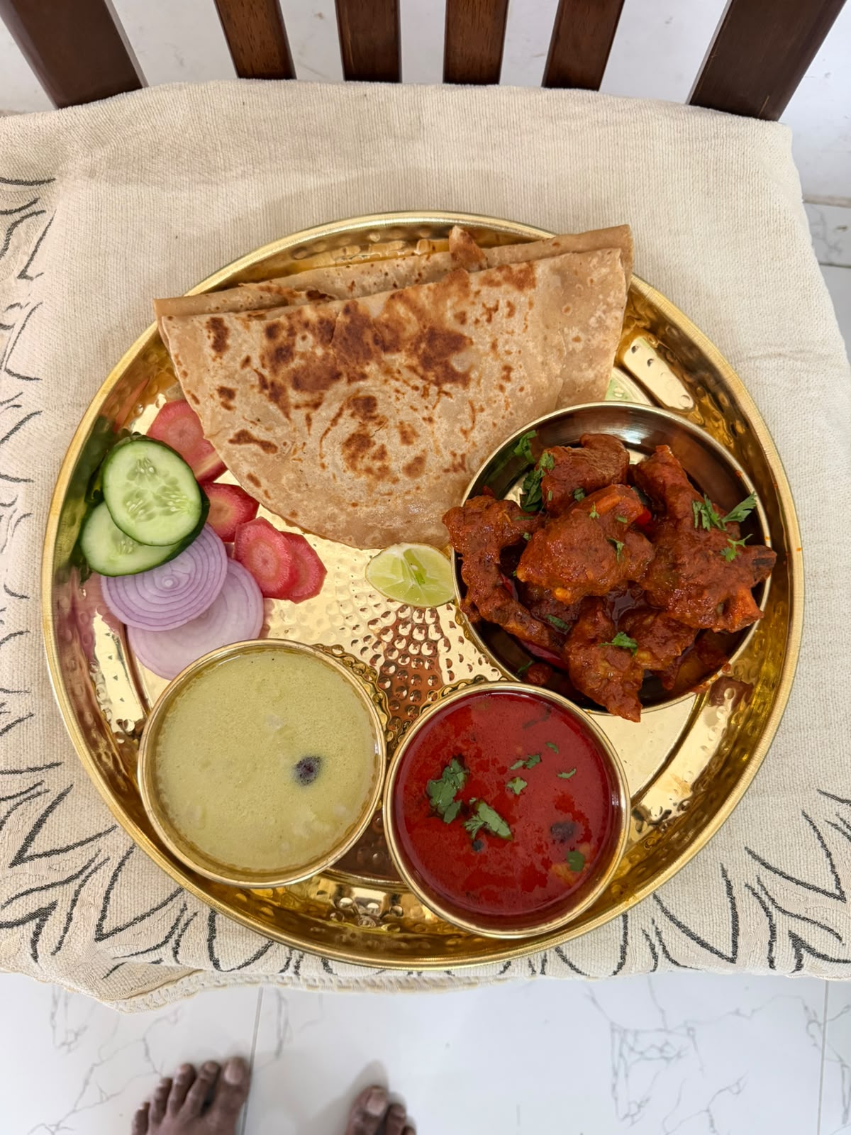 Mutton thali served on a brass plate