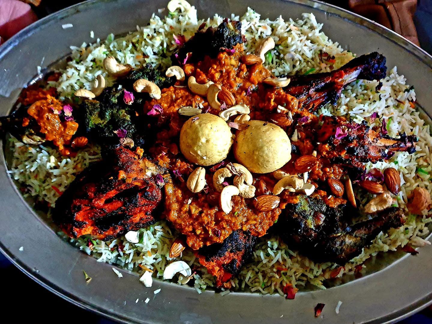 Grilled chicken platter over rice with cashews and almonds