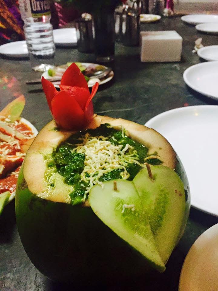 Green palak gravy served in a carved melon