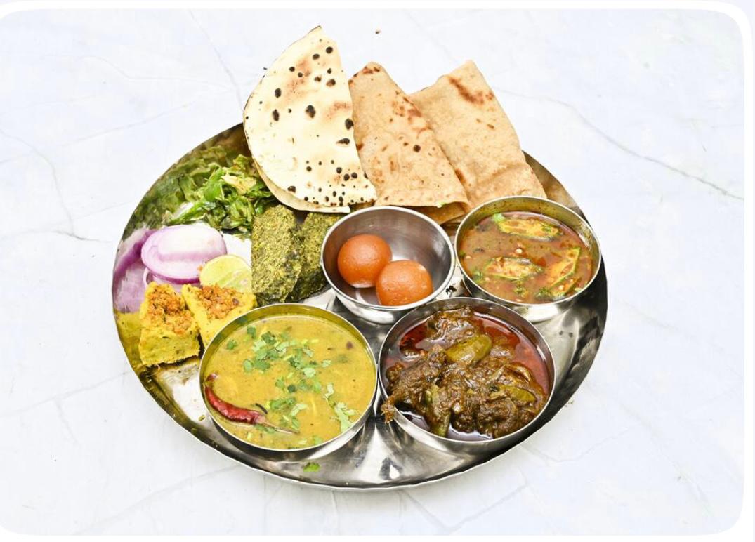 Vegetarian thali with dal, sabzi, rotis and sweets